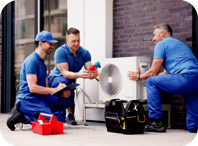 Technicians installing an outdoor air conditioning unit.