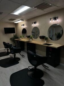 Hair salon stations with barber chairs and mirrors